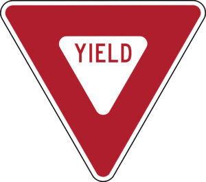 Red and white triangular sign pointed downward. Text reads "YIELD."